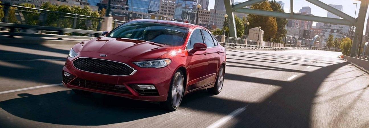 2019 Ford Fusion driving over a bridge in the city